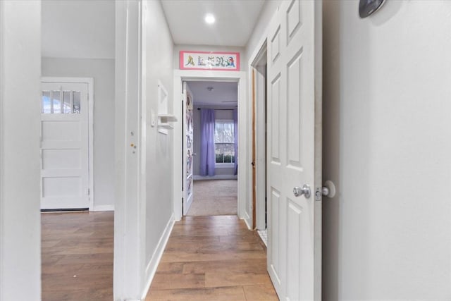 hallway with baseboards and wood finished floors