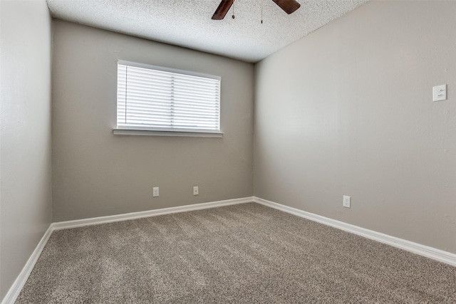 carpeted spare room featuring a textured ceiling, a ceiling fan, and baseboards