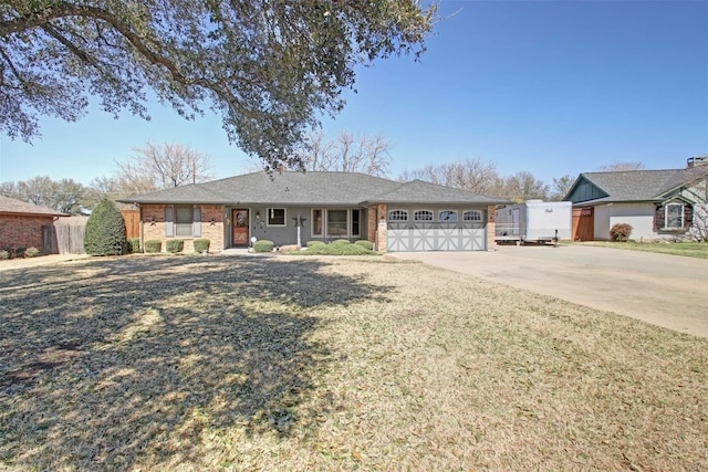 ranch-style home with brick siding, an attached garage, concrete driveway, and fence