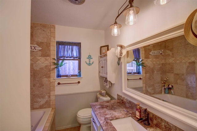 bathroom with vanity, toilet, a shower, and tiled bath