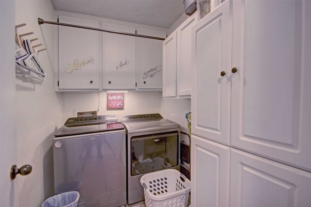 washroom with cabinet space and washing machine and clothes dryer