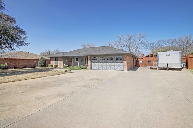 view of front of home featuring an attached garage, brick siding, and driveway