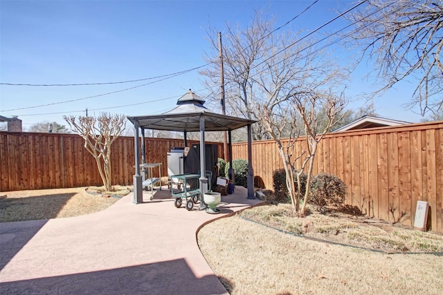 view of patio featuring a gazebo and a fenced backyard