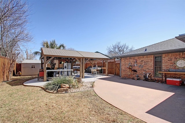 exterior space with a gazebo, a storage shed, an outbuilding, and a fenced backyard