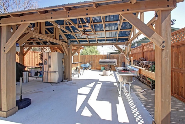 view of patio featuring a gazebo and a fenced backyard