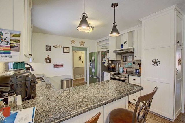 kitchen with under cabinet range hood, appliances with stainless steel finishes, white cabinetry, and a peninsula