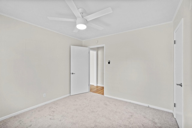 unfurnished bedroom featuring a ceiling fan, carpet, ornamental molding, and baseboards