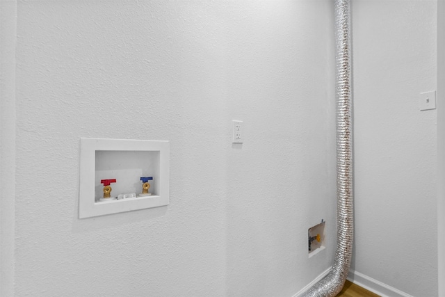 clothes washing area featuring washer hookup, laundry area, electric dryer hookup, and baseboards