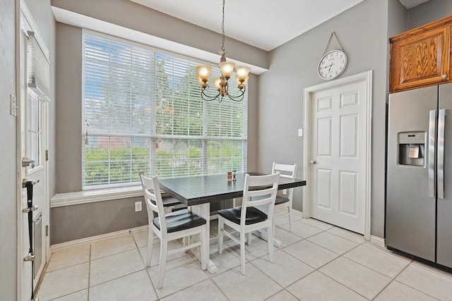 dining space with baseboards, light tile patterned flooring, and a notable chandelier