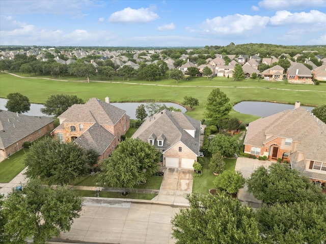 birds eye view of property featuring view of golf course, a water view, and a residential view