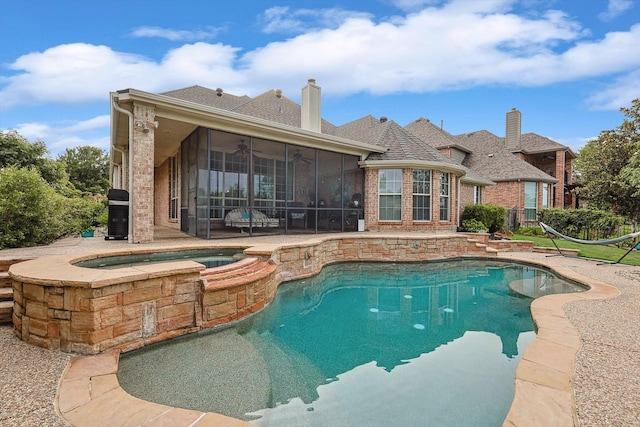 view of swimming pool featuring a ceiling fan, a fenced in pool, a sunroom, an in ground hot tub, and a patio area