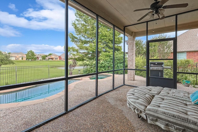 sunroom with a ceiling fan