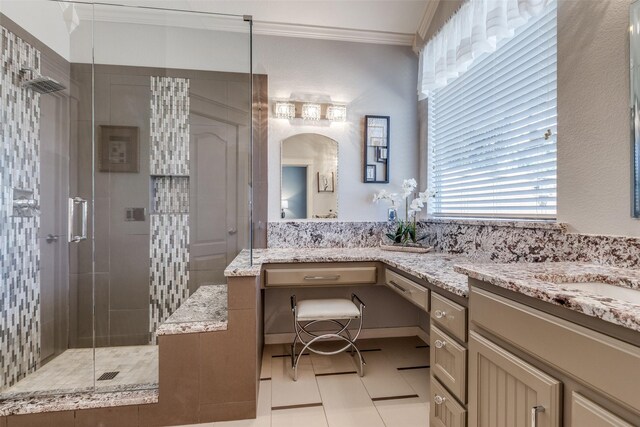 full bath featuring tile patterned floors, vanity, crown molding, and a walk in shower