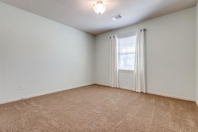 unfurnished room featuring carpet flooring, baseboards, and visible vents