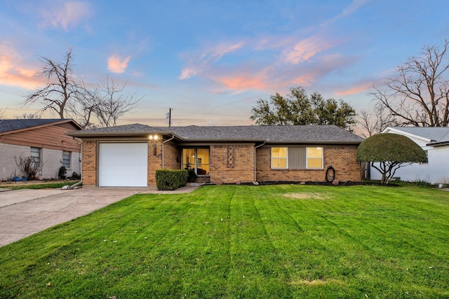 ranch-style house with a garage, a front yard, brick siding, and driveway