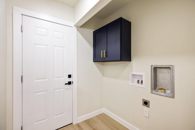 laundry area featuring washer hookup, baseboards, light wood-style floors, cabinet space, and electric dryer hookup