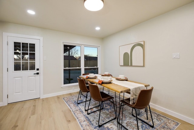 dining area featuring light wood-style flooring, baseboards, and recessed lighting