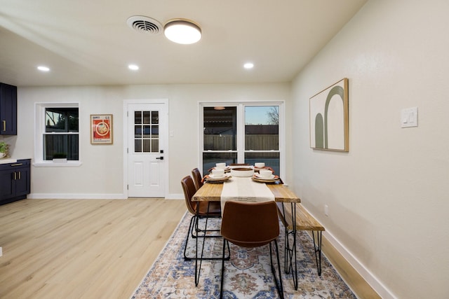 dining room featuring light wood-style floors, baseboards, visible vents, and recessed lighting