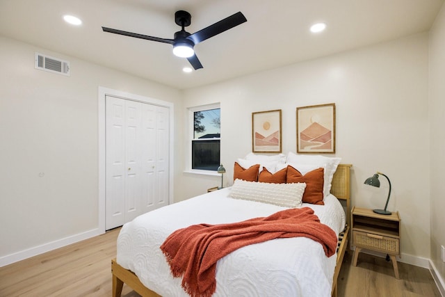 bedroom with light wood finished floors, a closet, visible vents, and recessed lighting