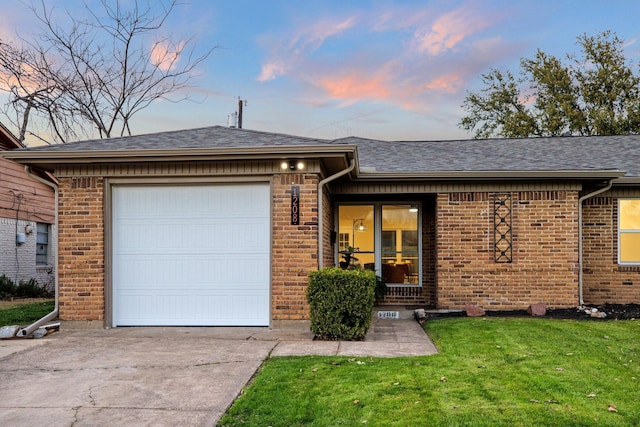 ranch-style home with driveway, brick siding, roof with shingles, and an attached garage