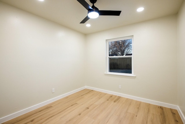 empty room with light wood finished floors, recessed lighting, and baseboards