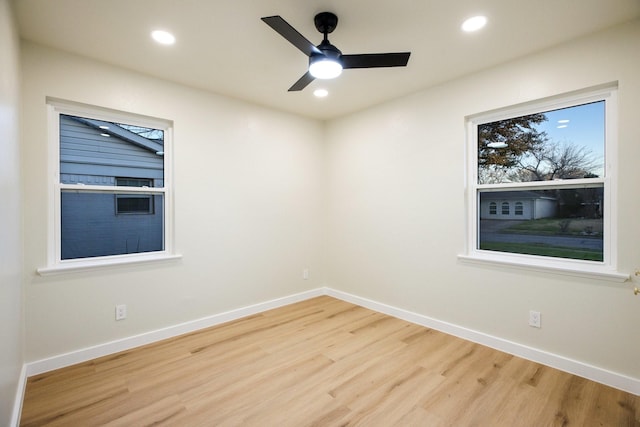 unfurnished room with a ceiling fan, baseboards, wood finished floors, and recessed lighting