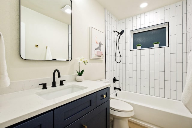 full bathroom featuring shower / washtub combination, vanity, and toilet