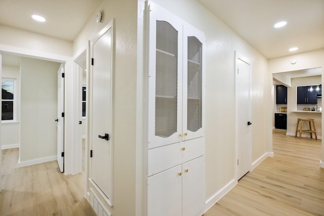 hallway featuring recessed lighting, visible vents, and light wood-style flooring