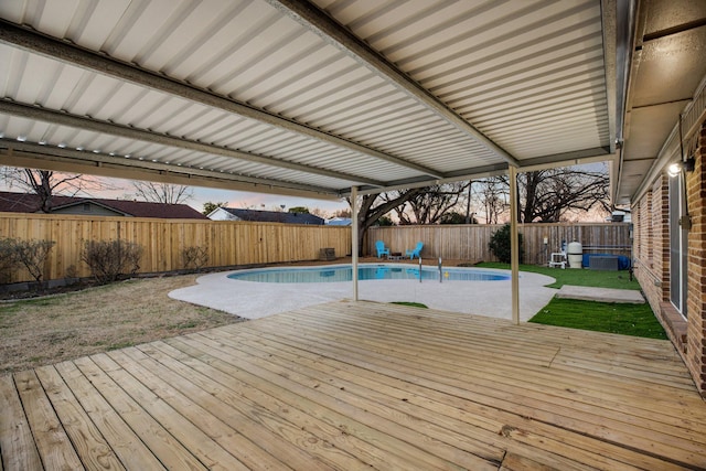 view of swimming pool with a fenced backyard, a deck, a fenced in pool, and a yard