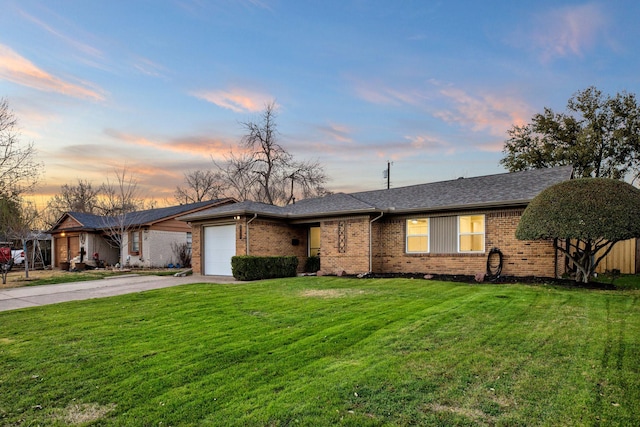 view of front of property featuring driveway, roof with shingles, an attached garage, a front lawn, and brick siding