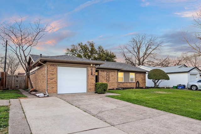 ranch-style house featuring a garage, brick siding, fence, concrete driveway, and a yard