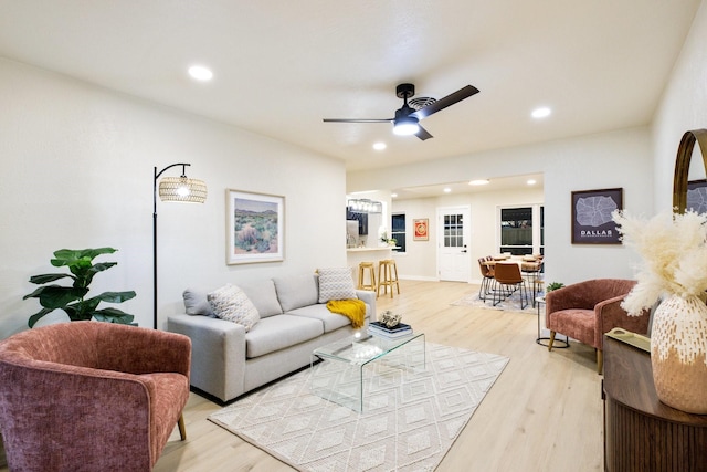 living room featuring a ceiling fan, light wood-style flooring, and recessed lighting