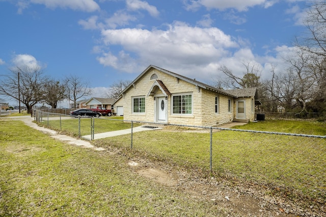 bungalow with fence private yard, stone siding, and a front lawn