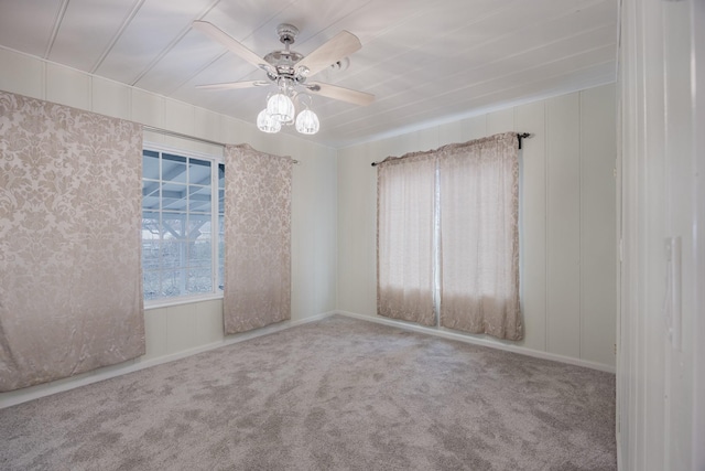 carpeted spare room with ceiling fan