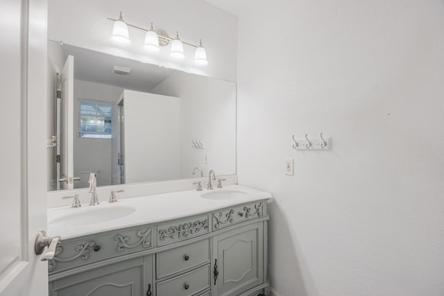 full bathroom featuring double vanity and a sink