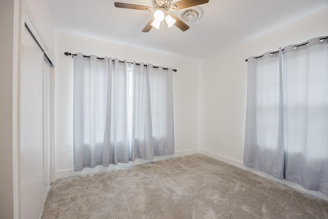 carpeted empty room with ceiling fan