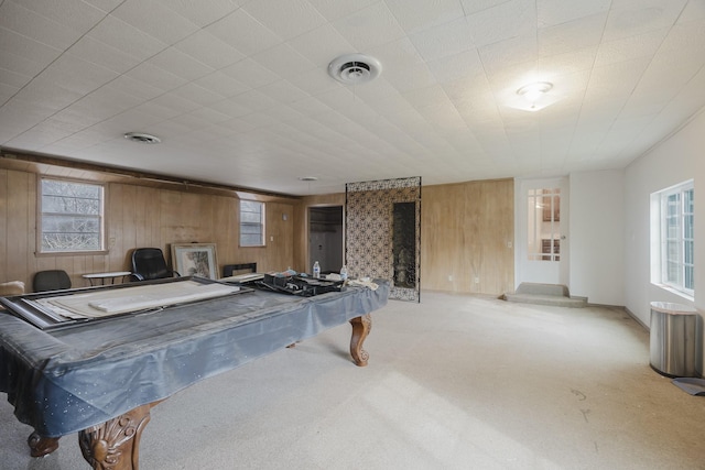 game room featuring carpet, visible vents, and wooden walls