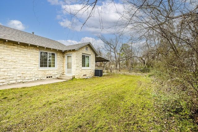 view of yard with entry steps, fence, and central air condition unit