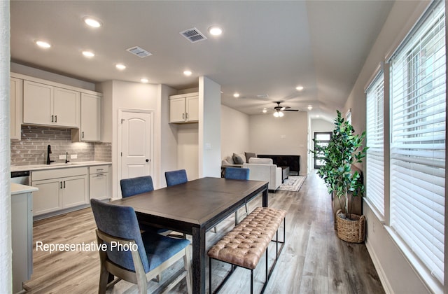 dining room with light wood-type flooring, visible vents, a ceiling fan, and recessed lighting