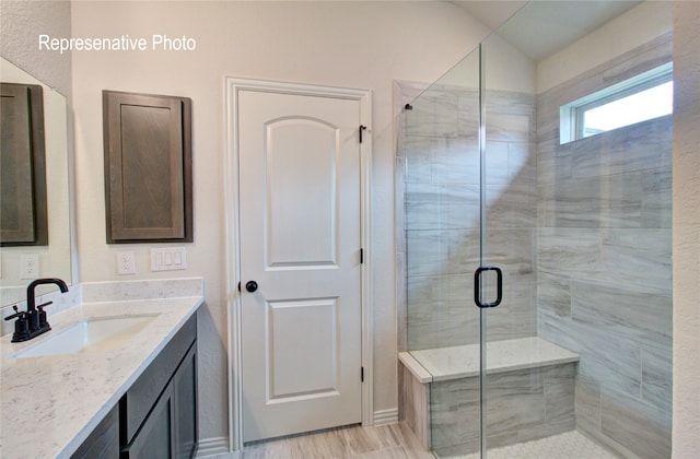 full bathroom featuring a shower stall, vaulted ceiling, and vanity