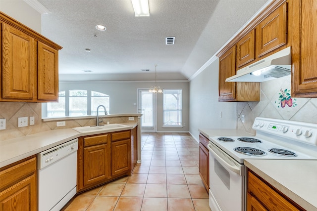 kitchen with under cabinet range hood, white appliances, a sink, visible vents, and brown cabinets