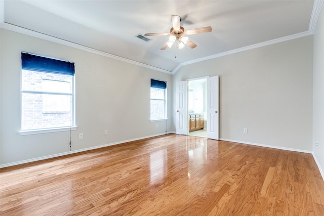 empty room featuring crown molding, light wood finished floors, visible vents, ceiling fan, and baseboards