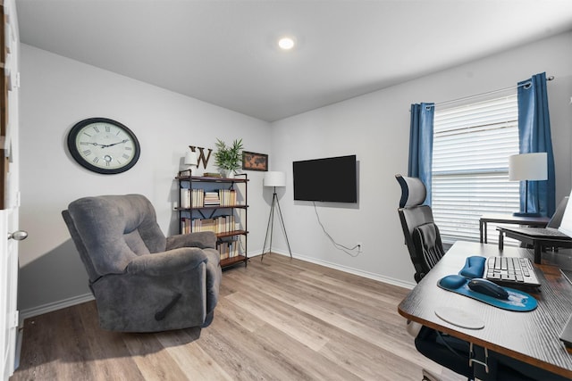 office area with light wood-type flooring and baseboards