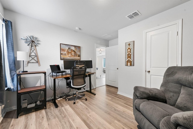 office area featuring wood finished floors, visible vents, and baseboards