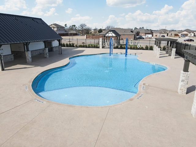 pool featuring a patio area, fence, and a gazebo