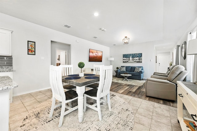 dining area with visible vents, baseboards, and light tile patterned floors