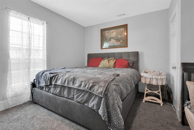 carpeted bedroom featuring visible vents