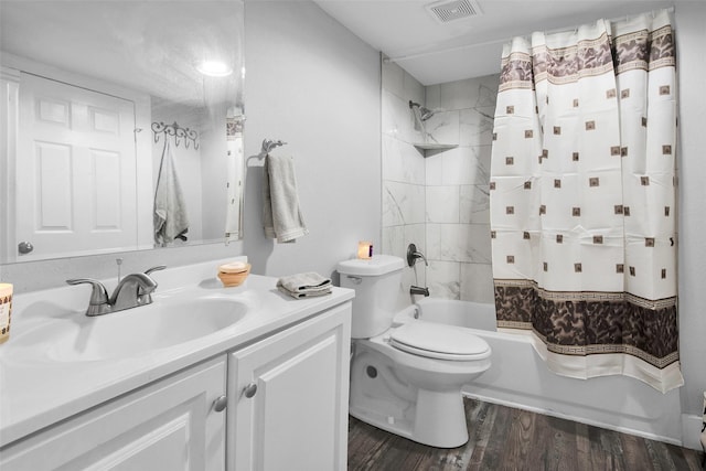 full bath featuring toilet, wood finished floors, vanity, visible vents, and shower / bath combo