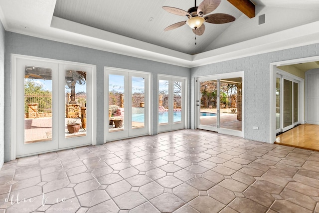 interior space featuring a ceiling fan, french doors, and vaulted ceiling with beams