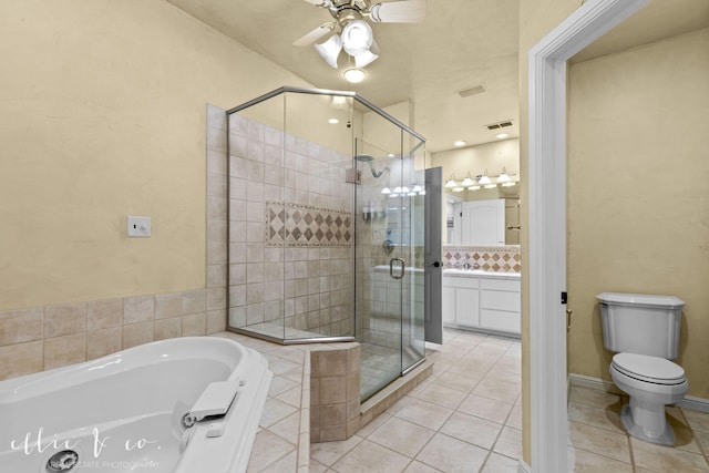 full bath featuring a garden tub, a shower stall, vanity, and tile patterned floors